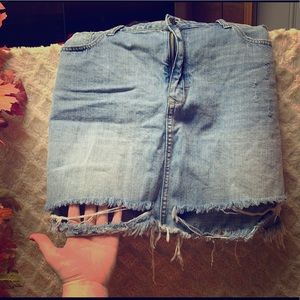 Distressed light wash denim skirt with pockets.